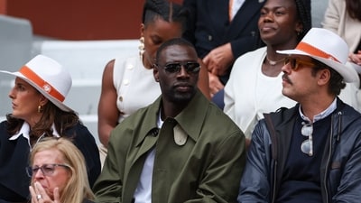 French actors Omar Sy (C) and Laurent Lafitte (R) attend the women's singles final match on day 14. (AFP) French actors Omar Sy (C) and Laurent Lafitte (R) attend the women's singles final match on day 14. (AFP)
