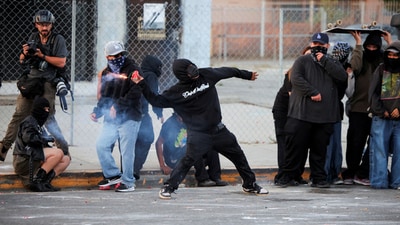 A protester throws a firework during a standoff between police and protesters following multiple detentions by Immigration and Customs Enforcement (ICE), in the Los Angeles County city of Paramount, California, U.S., June 7. (Reuters) A protester throws a firework during a standoff between police and protesters following multiple detentions by Immigration and Customs Enforcement (ICE), in the Los Angeles County city of Paramount, California, U.S., June 7. (Reuters)