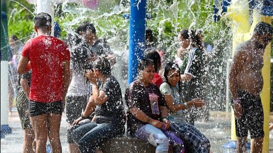 People at the Noida Sector 38 Water Park on Monday. (Sunil Ghosh/HT photo)