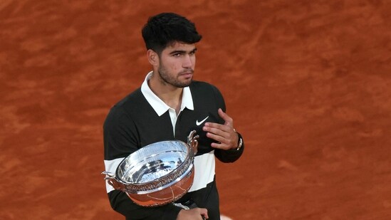 Spain's Carlos Alcaraz poses with his trophy after his victory in the men's singles final match against Italy's Jannik Sinner (AFP)