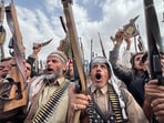 Protesters hold weapons, during a demonstration of predominantly Houthi supporters to show solidarity with Palestinians in the Gaza Strip and to condemn US strikes in Yemen.