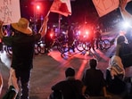 Demonstrators display signs in front of law enforcement officers during a rally in solidarity with Los Angeles protests against federal immigration sweeps, in Austin, Texas, U.S., June 9, 2025. (REUTERS/Joel Angel Juarez)