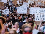 Demonstrators display signs during a rally in solidarity with Los Angeles protests against federal immigration sweeps, in Austin, Texas, U.S., June 9, 2025. (REUTERS/Joel Angel Juarez)