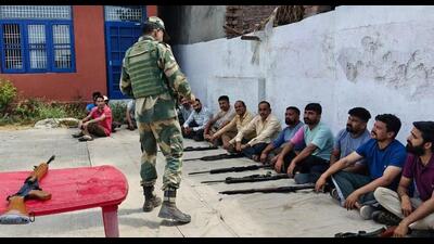 A BSF personnel training village defence guards (VDGs) in operating semi-automatic self-loading rifles (SLRs) at a camp in the RS Pura sector of Jammu district on Tuesday. (HT Photo) A BSF personnel training village defence guards (VDGs) in operating semi-automatic self-loading rifles (SLRs) at a camp in the RS Pura sector of Jammu district on Tuesday. (HT Photo)