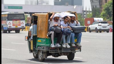 People seen covering heads and faces to protect themselveson a hot summer day in Gurugram on Tuesday. (Parveen Kumar/Hindustan Times)