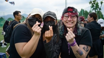 Fans of K-pop boy band BTS members RM and V pose at an outdoor sporting facility in Chuncheon on June 10, 2025, after the two band members were released from 18 months of South Korean military service. Hundreds of fans gathered near two army bases just outside of the capital Seoul where band leader RM -- recently named "Favorite K-pop Artist" at the American Music Awards -- and singer V were discharged. (AFP) Fans of K-pop boy band BTS members RM and V pose at an outdoor sporting facility in Chuncheon on June 10, 2025, after the two band members were released from 18 months of South Korean military service. Hundreds of fans gathered near two army bases just outside of the capital Seoul where band leader RM -- recently named "Favorite K-pop Artist" at the American Music Awards -- and singer V were discharged. (AFP)