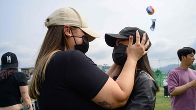 Fans of K-pop boy band BTS members RM and V hug each other at an outdoor sporting facility in Chuncheon on June 10, 2025, after the two band members were released from 18 months of South Korean military service. Hundreds of fans gathered near two army bases just outside of the capital Seoul where band leader RM -- recently named "Favorite K-pop Artist" at the American Music Awards -- and singer V were discharged. (AFP) Fans of K-pop boy band BTS members RM and V hug each other at an outdoor sporting facility in Chuncheon on June 10, 2025, after the two band members were released from 18 months of South Korean military service. Hundreds of fans gathered near two army bases just outside of the capital Seoul where band leader RM -- recently named "Favorite K-pop Artist" at the American Music Awards -- and singer V were discharged. (AFP)