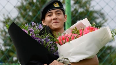 K-pop boy band BTS member V looks on while holding flower bouquets at an outdoor sporting facility in Chuncheon on June 10, 2025, after his release with bandmate RM from 18 months of South Korean military service. Hundreds of fans gathered near two army bases just outside of the capital Seoul where band leader RM -- recently named "Favorite K-pop Artist" at the American Music Awards -- and singer V were discharged. (AFP) K-pop boy band BTS member V looks on while holding flower bouquets at an outdoor sporting facility in Chuncheon on June 10, 2025, after his release with bandmate RM from 18 months of South Korean military service. Hundreds of fans gathered near two army bases just outside of the capital Seoul where band leader RM -- recently named "Favorite K-pop Artist" at the American Music Awards -- and singer V were discharged. (AFP)