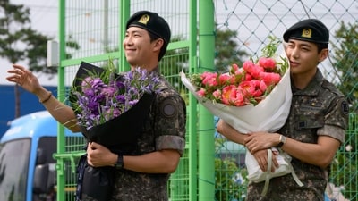 K-pop boy band BTS members RM (L) and V gesture as they hold flower bouquets at an outdoor sporting facility in Chuncheon on June 10, 2025, after their release from 18 months of South Korean military service. Hundreds of fans gathered near two army bases just outside of the capital Seoul where band leader RM -- recently named "Favorite K-pop Artist" at the American Music Awards -- and singer V were discharged. (AFP) K-pop boy band BTS members RM (L) and V gesture as they hold flower bouquets at an outdoor sporting facility in Chuncheon on June 10, 2025, after their release from 18 months of South Korean military service. Hundreds of fans gathered near two army bases just outside of the capital Seoul where band leader RM -- recently named "Favorite K-pop Artist" at the American Music Awards -- and singer V were discharged. (AFP)