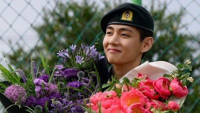 K-pop boy band BTS member V looks on while holding flower bouquets at an outdoor sporting facility in Chuncheon on June 10, 2025, after his release with bandmate RM from 18 months of South Korean military service. Hundreds of fans gathered near two army bases just outside of the capital Seoul where band leader RM -- recently named "Favorite K-pop Artist" at the American Music Awards -- and singer V were discharged. (AFP) K-pop boy band BTS member V looks on while holding flower bouquets at an outdoor sporting facility in Chuncheon on June 10, 2025, after his release with bandmate RM from 18 months of South Korean military service. Hundreds of fans gathered near two army bases just outside of the capital Seoul where band leader RM -- recently named "Favorite K-pop Artist" at the American Music Awards -- and singer V were discharged. (AFP)