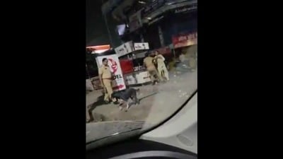 Screen grab from the CCTV footage shows cops grabbing woman by collar (Sourced) Screen grab from the CCTV footage shows cops grabbing woman by collar (Sourced)