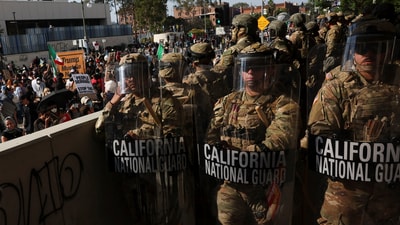 Members of the California National Guard stand in a line, blocking an entrance to the Federal Building, as demonstrators gather nearby, during protests against immigration sweeps, in Los Angeles, California, U.S. June 9, 2025. (REUTERS/Leah Millis) (REUTERS)