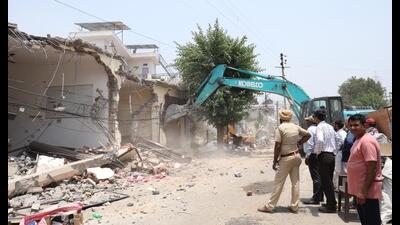 Unauthorised structures being razed during the demolition drive in Kaimbwala village on Tuesday. (HT File) Unauthorised structures being razed during the demolition drive in Kaimbwala village on Tuesday. (HT File)