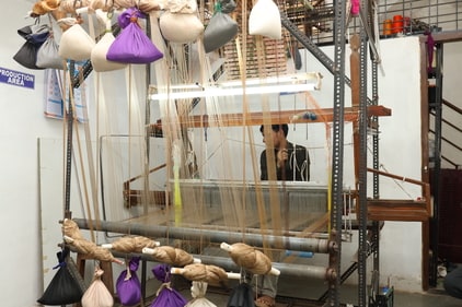 Local artisans weaving sarees (Fabindia)
