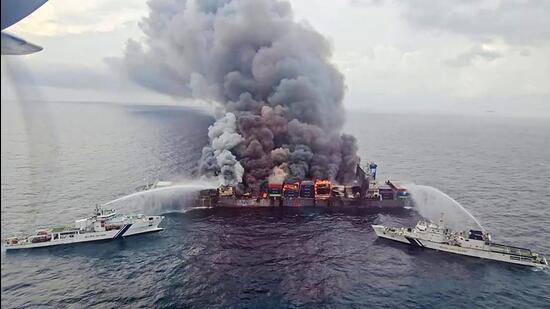 Indian Coast Guard ships carry out the firefighting operation on Tuesday after a fire broke out on a Singapore-flagged ship following a container explosion off the Kerala coast on Monday (AFP)