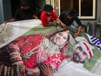 Indore: Family members of Raja Raghuvanshi, who was murdered during his honeymoon in Meghalaya, cut out the picture of his wife Sonam Raghuvanshi from a poster. Indore: Family members of Raja Raghuvanshi, who was murdered during his honeymoon in Meghalaya, cut out the picture of his wife Sonam Raghuvanshi from a poster.