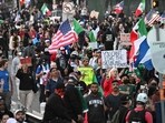 Demonstrators march in front of the Federal Building before the curfew imposed by LA Mayor Karen Bass goes into effect.