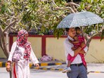 People take protection against the scorching sun on a hot summer day, in New Delhi. People take protection against the scorching sun on a hot summer day, in New Delhi.