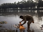Ansar Abbas, 32, cools watermelons in the Upper Chenab Canal to sell during a heatwave in Sialkot, Pakistan
