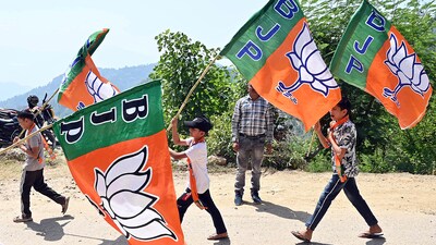 Children carry BJP flags during a rally. (ANI) Children carry BJP flags during a rally. (ANI)