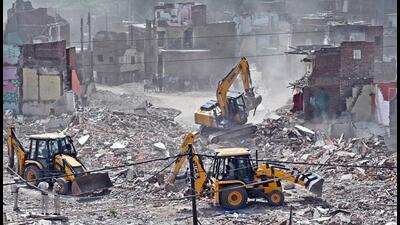 Bulldozers at the Bhoomiheen Camp near Kalkaji on Wednesday. (Sanjeev Verma/HT Photo) Bulldozers at the Bhoomiheen Camp near Kalkaji on Wednesday. (Sanjeev Verma/HT Photo)