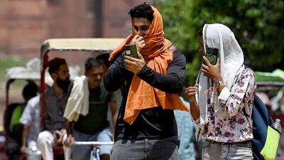 Men cover themselves with a cloth on a hot summer day in the old quarters of Delhi on Tuesday. (AFP) Men cover themselves with a cloth on a hot summer day in the old quarters of Delhi on Tuesday. (AFP)