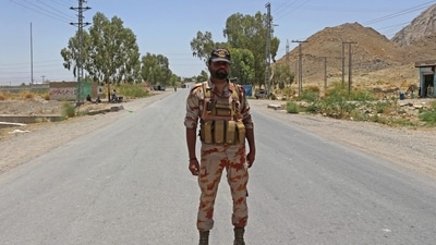A security personnel stands guard along a street near the site of a school bus bombing in the Khuzdar district of Balochistan province (AFP/Representative)