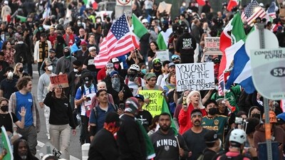 Demonstrators march in front of the Federal Building before the curfew imposed by LA Mayor Karen Bass goes into effect. (AFP) Demonstrators march in front of the Federal Building before the curfew imposed by LA Mayor Karen Bass goes into effect. (AFP)