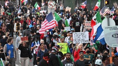 Demonstrators march in front of the Federal Building before the curfew imposed by LA Mayor Karen Bass goes into effect. (AFP)