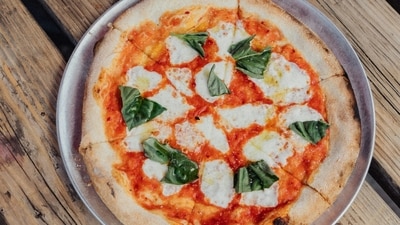The Margherita pizza was created as a special tribute to Queen Margherita of Savoy (unsplash) The Margherita pizza was created as a special tribute to Queen Margherita of Savoy (unsplash)