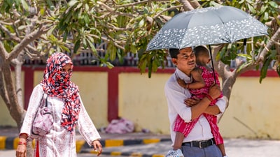 People take protection against the scorching sun on a hot summer day, in New Delhi. (PTI) People take protection against the scorching sun on a hot summer day, in New Delhi. (PTI)
