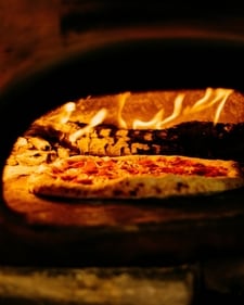 A splash of truffle oil or extra virgin olive oil will elevate your Margherita pizza (unsplash) A splash of truffle oil or extra virgin olive oil will elevate your Margherita pizza (unsplash)