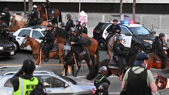 Mounted Police moves on to clear the street as an overnight curfew went into effect in protest-hit downtown Los Angeles on June 10.(AFP)