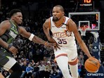 Phoenix Suns forward Kevin Durant (35) brings the ball up as Minnesota Timberwolves guard Anthony Edwards (5) defends him in the fourth quarter