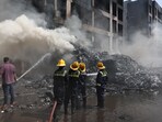 Firefighters work to put out a fire at the site where an Air India plane crashed in Ahmedabad, India, June 12, 2025