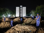Security personnel stand at the crash site after an Air India aircraft, bound for London's Gatwick Airport, crashed during take-off from an airport in Ahmedabad.