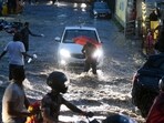 People wade through the waterlogged street amid heavy rainfall, at Malakpet, in Hyderabad on July 24, 2023. People wade through the waterlogged street amid heavy rainfall, at Malakpet, in Hyderabad on July 24, 2023.