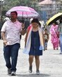 People walking under umbrellas to protect themselves from scorching heat on The Ridge in Shimla on Wednesday. (HT Photo) People walking under umbrellas to protect themselves from scorching heat on The Ridge in Shimla on Wednesday. (HT Photo)