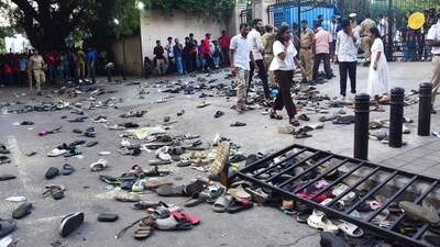 Fans stand next to abandoned shoes and a fallen barriers following a stampede during RCB’s IPL victory celebrations on June 4. (AFP) Fans stand next to abandoned shoes and a fallen barriers following a stampede during RCB’s IPL victory celebrations on June 4. (AFP)