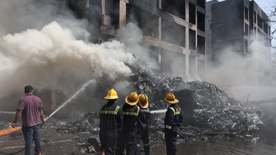 Firefighters work to put out a fire at the site where an Air India plane crashed in Ahmedabad, India, June 12, 2025 (Reuters)