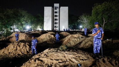 Security personnel stand at the crash site after an Air India aircraft, bound for London's Gatwick Airport, crashed during take-off from an airport in Ahmedabad. (REUTERS)
