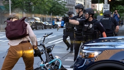 Seattle police officers direct spray pepper at protesters gathered outside the Henry M. Jackson Federal Building, in Seattle, Tuesday, June 10, 2025. (AP) Seattle police officers direct spray pepper at protesters gathered outside the Henry M. Jackson Federal Building, in Seattle, Tuesday, June 10, 2025. (AP)