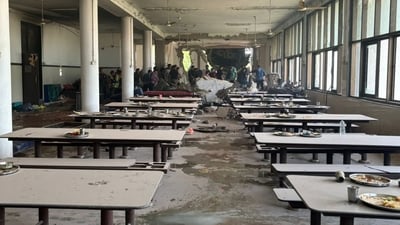 The visual shows dust enveloping the mess area with plates of uneatedn food still on tables as the sudden plane crash devastated the densely populated area in Ahmedabad. (Raju Shinde/Hindustan Times) The visual shows dust enveloping the mess area with plates of uneatedn food still on tables as the sudden plane crash devastated the densely populated area in Ahmedabad. (Raju Shinde/Hindustan Times)