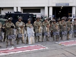 National Guard members stand guard outside the Edward R. Roybal Federal Building, during a protest against federal immigration sweeps, in Los Angeles, California, U.S., June 12, 2025. REUTERS/David Ryder
