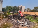 Ahmedabad: People look at the debris of the Air India plane that crashed moments after taking off from the airport, in Ahmedabad, Thursday, June 12. Ahmedabad: People look at the debris of the Air India plane that crashed moments after taking off from the airport, in Ahmedabad, Thursday, June 12.