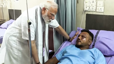 Prime Minister Narendra Modi meets and enquires about the health condition of Vishwash Kumar Ramesh, the lone survivor of the Air India AI-171 flight crash, at a hospital in Ahmedabad on Friday. (ANI ) Prime Minister Narendra Modi meets and enquires about the health condition of Vishwash Kumar Ramesh, the lone survivor of the Air India AI-171 flight crash, at a hospital in Ahmedabad on Friday. (ANI )