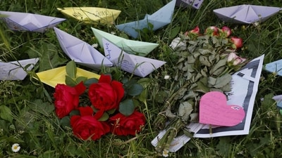 People leave paper boats with notes on them and flowers at a makeshift memorial site in front of the school the day after ten people died in a school shooting, on June 12, 2025 in Graz, southeastern Austria. (AFP) People leave paper boats with notes on them and flowers at a makeshift memorial site in front of the school the day after ten people died in a school shooting, on June 12, 2025 in Graz, southeastern Austria. (AFP)