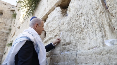 Israeli Prime Minister Benjamin Netanyahu placed the note, "the people shall rise up as a lion", in between the bricks of the Western Wall, Judaism's holiest prayer site, (Reuters)