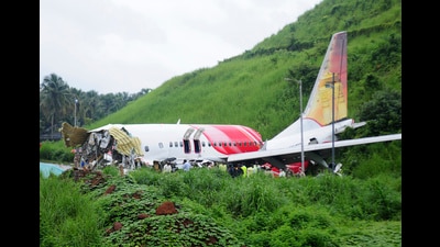Officials stand near the debris of the Air India Express flight that skidded off a runway while landing in Kozhikode in 2020. (AP)