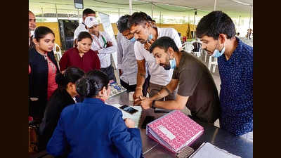 People submit documents at a help desk for claiming luggage and other belongings of their deceased relatives on Friday. (PTI) People submit documents at a help desk for claiming luggage and other belongings of their deceased relatives on Friday. (PTI)